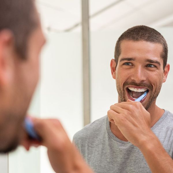 man brushing teeth