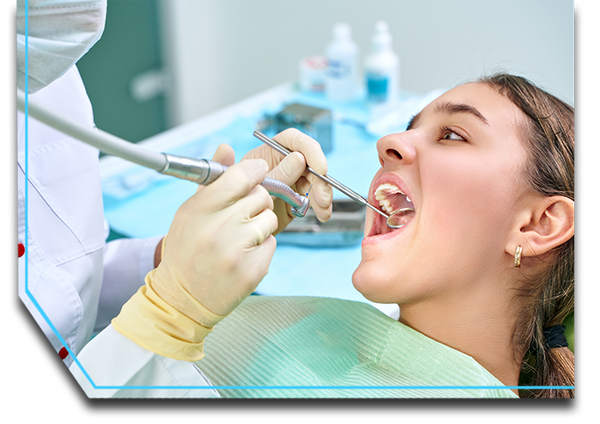 Dental hygienist cleaning a child’s teeth.
