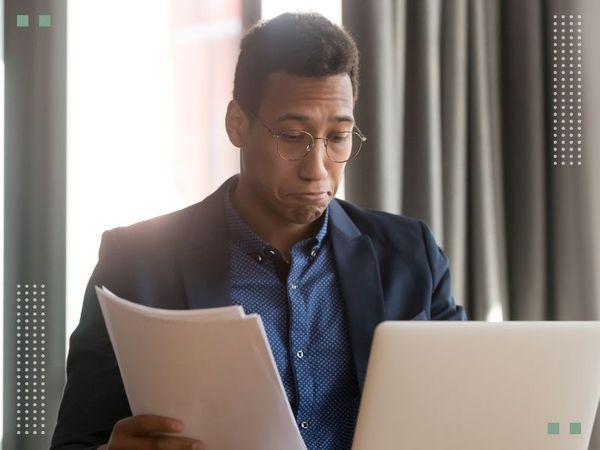 confused man looking over paperwork