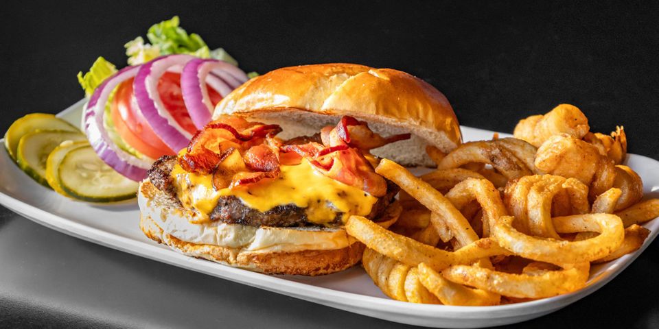 a delicious looking burger with onion rings 4 Refreshing Benefits of Dining Out Hero.jpg