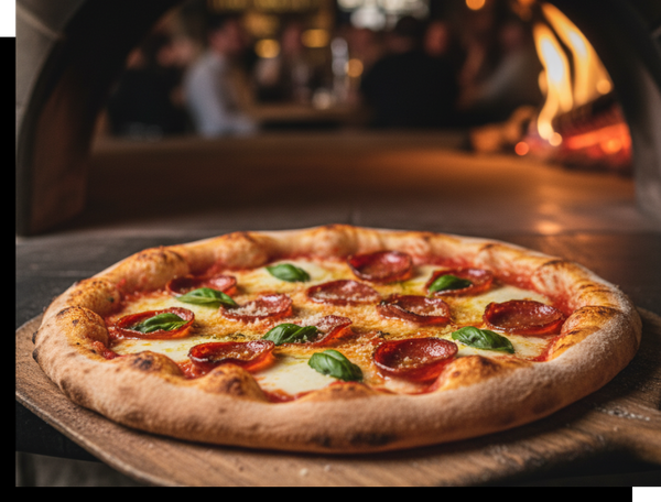 A perfectly baked pepperoni pizza with fresh basil leaves, resting on a wooden peel in front of a glowing wood-fired pizza oven with a blurred restaurant background.