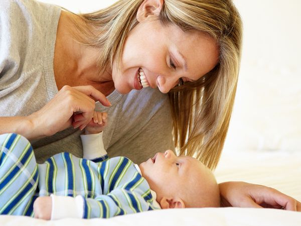 A mother or infant care giver talking to an infant