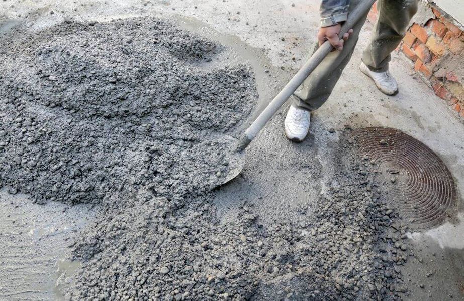person shoveling concrete