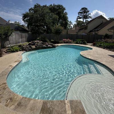 Finished tanning ledge and fresh plaster on a Kingwood, TX pool after renovation by Express Pool Plastering