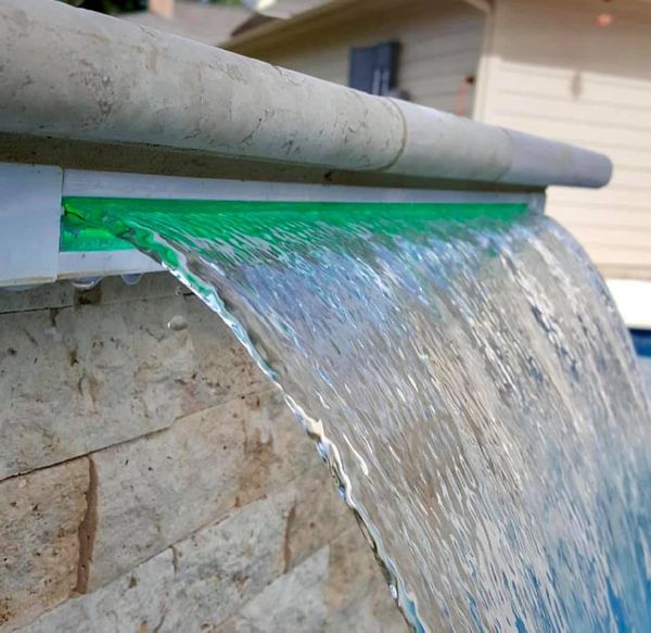 Sheer descent water feature on a Houston pool checked for leaks