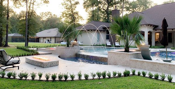 Houston home with a pool, deck fountains and a fire pit