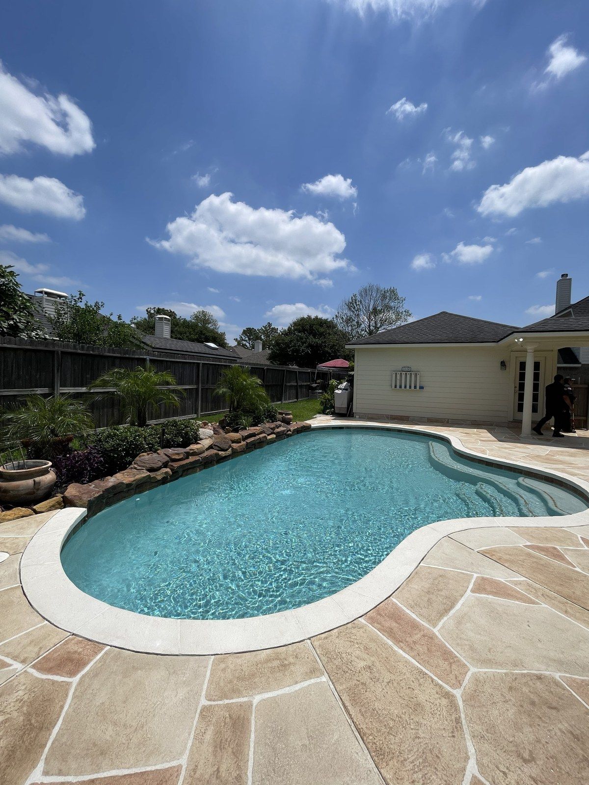 Restored Houston pool with clean coping and a flagstone deck