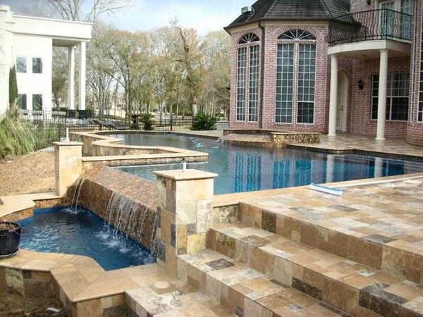 Travertine steps and coping beside a Houston swimming pool