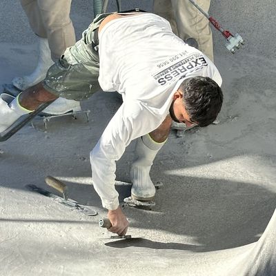 Express Pool Plastering crew hand-troweling new plaster during a full pool renovation in The Woodlands, TX
