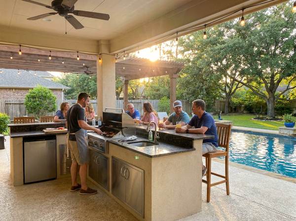 Custom Houston outdoor kitchen with built-in grill beside the pool