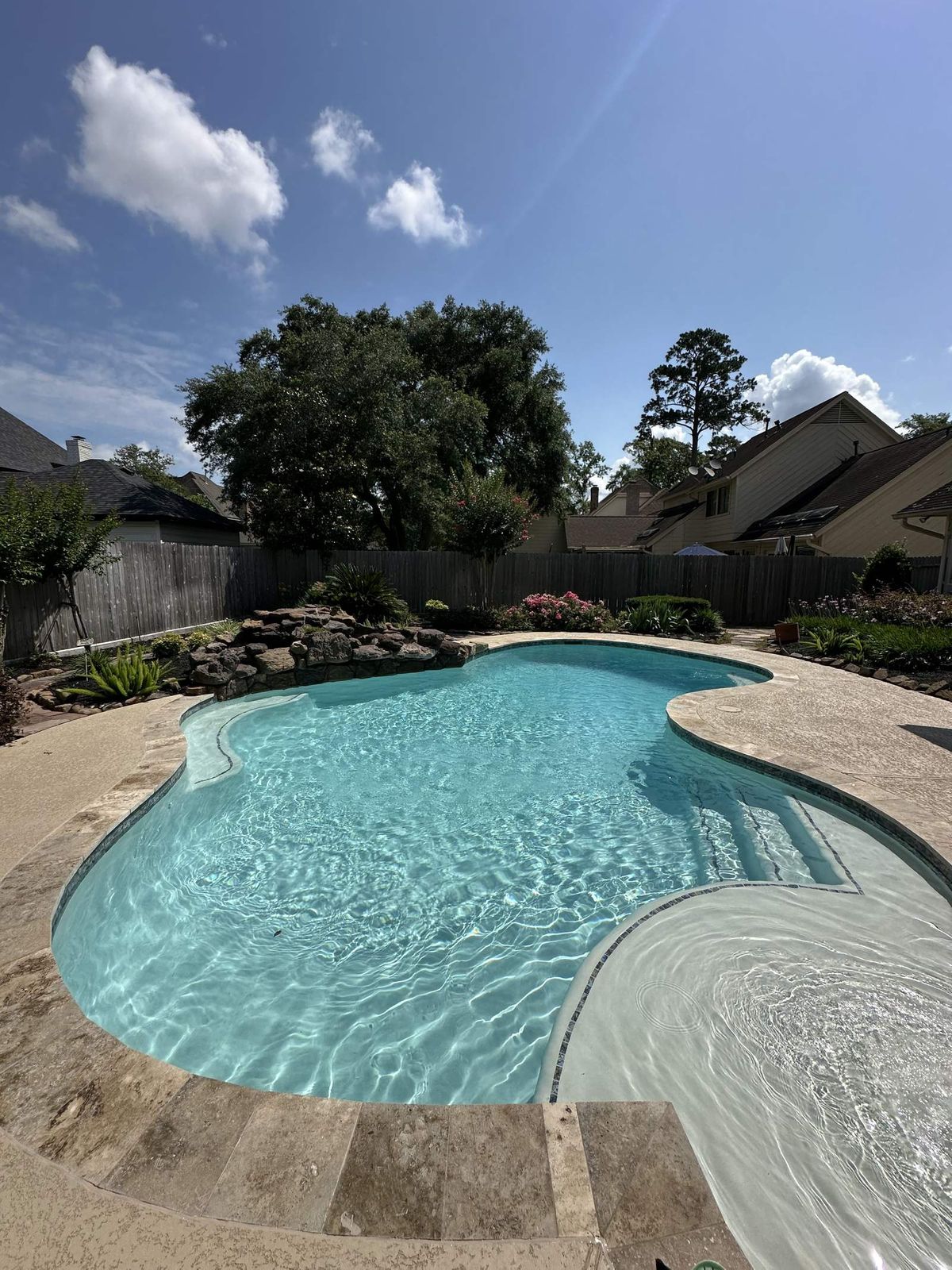 Finished tanning ledge and fresh plaster on a Kingwood, TX pool after renovation by Express Pool Plastering