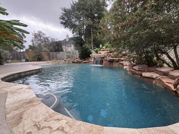 Freeform Houston pool with a rock waterfall and a smooth, watertight finish