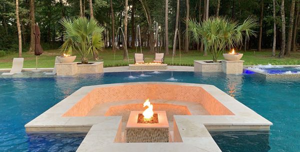 Houston pool with a raised spa and a built-in fire feature