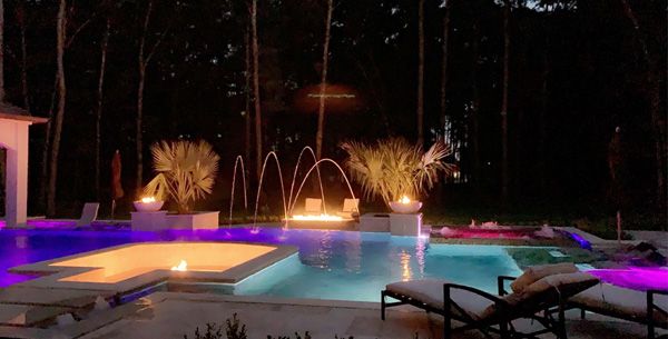Houston pool with colour-changing LED lighting in purple and pink at night