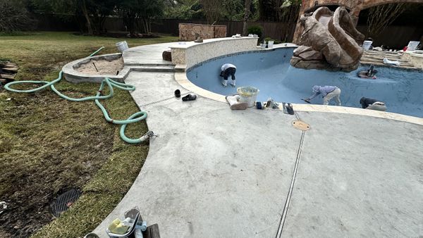 Drained pool shell prepared for plaster repair in Houston
