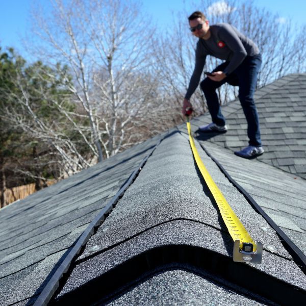 Contractor measuring roof