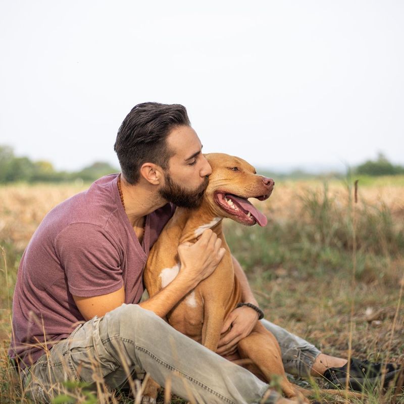 guy kissing his dog