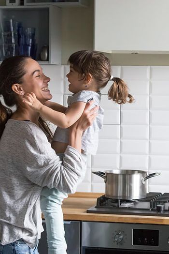 woman with child in kitchen