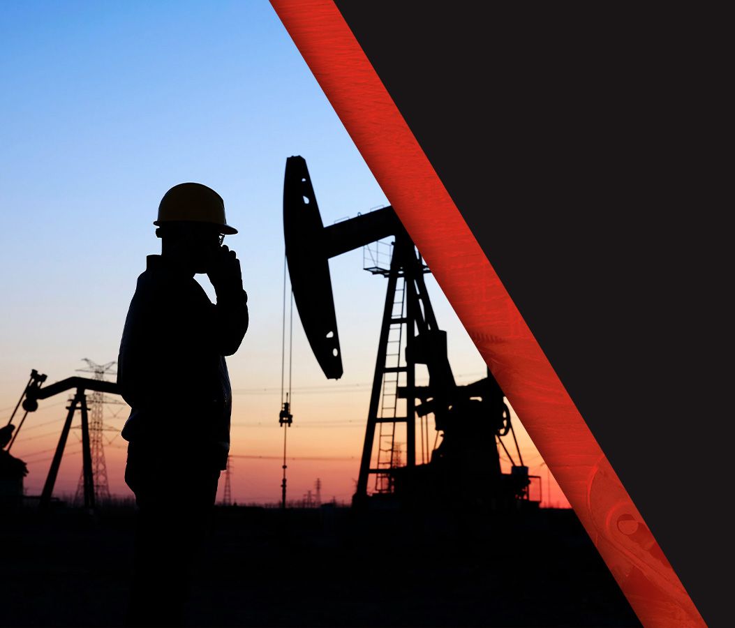 Oil field technician at field during sunset