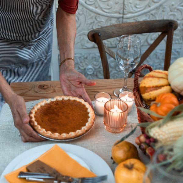 serving pumpkin pie at Thanksgiving table