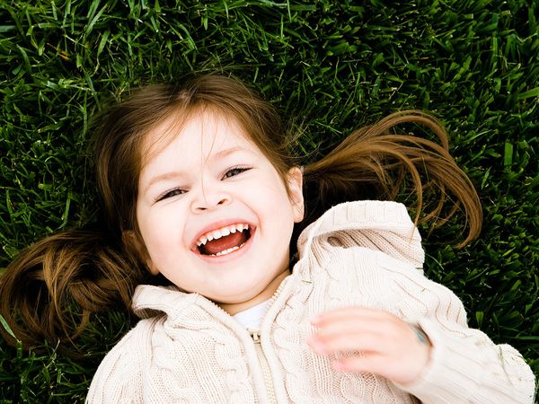 A young child playing outside at preschool.