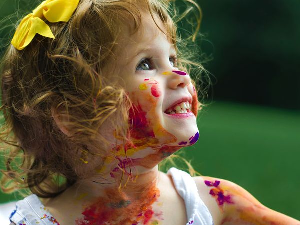  A toddler playing with paint.