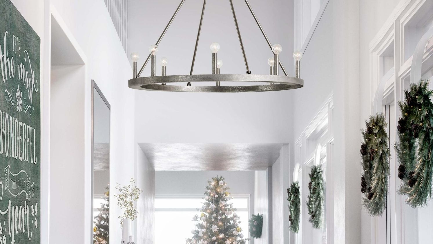 Chandelier hanging in a hallway with holiday decor