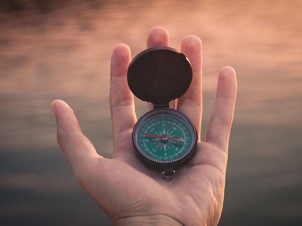 Person holding a compass