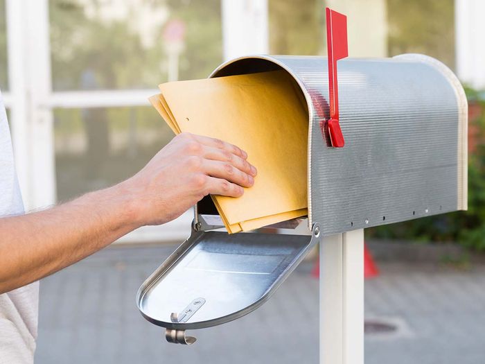 dropping off mail in mailbox