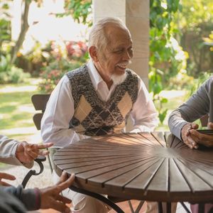 senior man sitting at table 