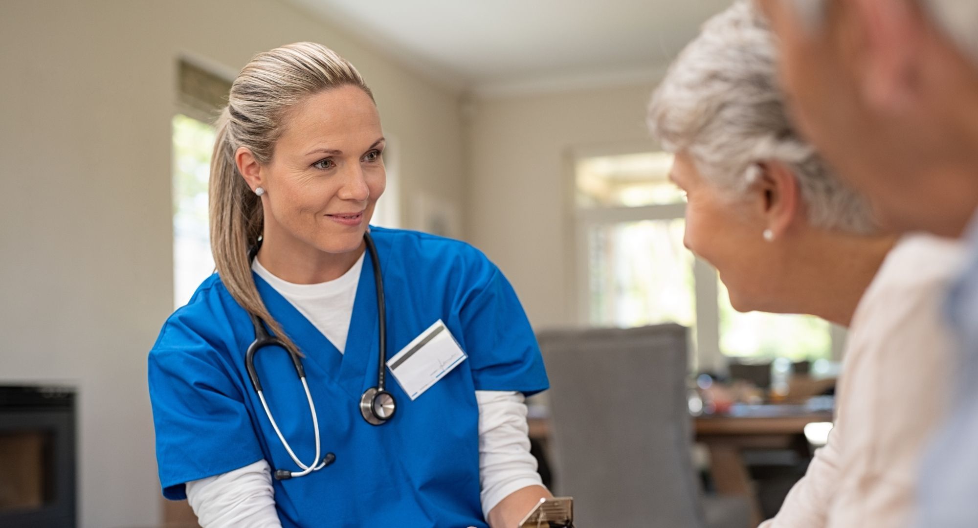 nurse talks with older couple