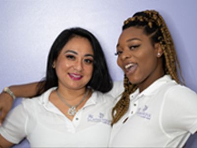 Two woman standing together and smiling with their lash extensions from Diva’s Wink Lash Bar