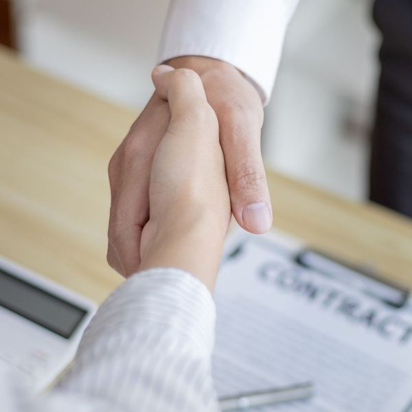 shaking hands over a contract