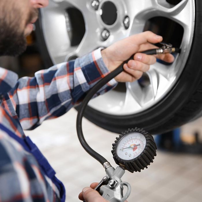 Mechanic checking tire pressure