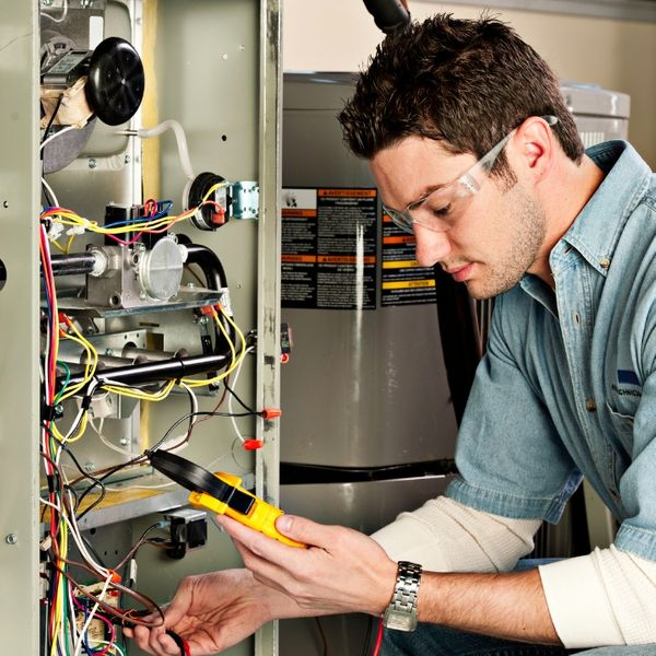 man fixing furnace