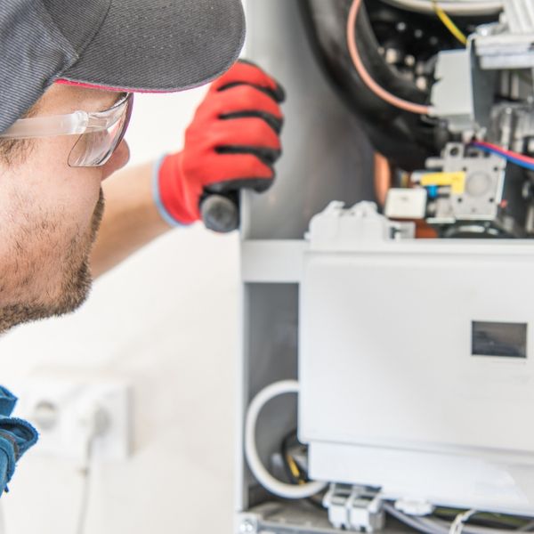 man fixing furnace