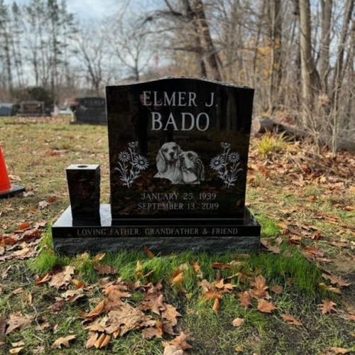 headstone with leaves around it