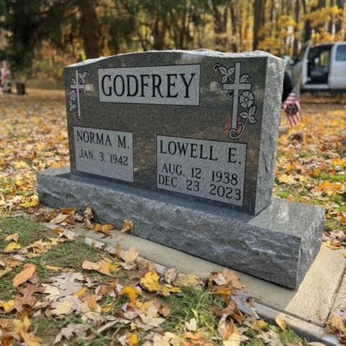 headstone with leaves around it