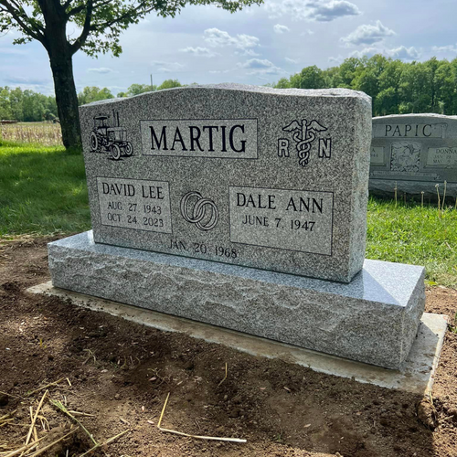 engraved headstone with art and tribute