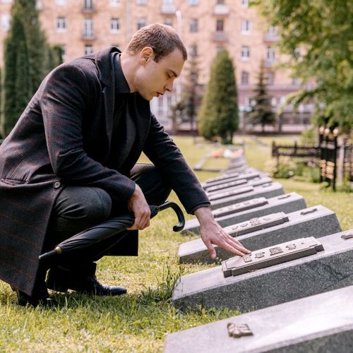 man visiting a grave