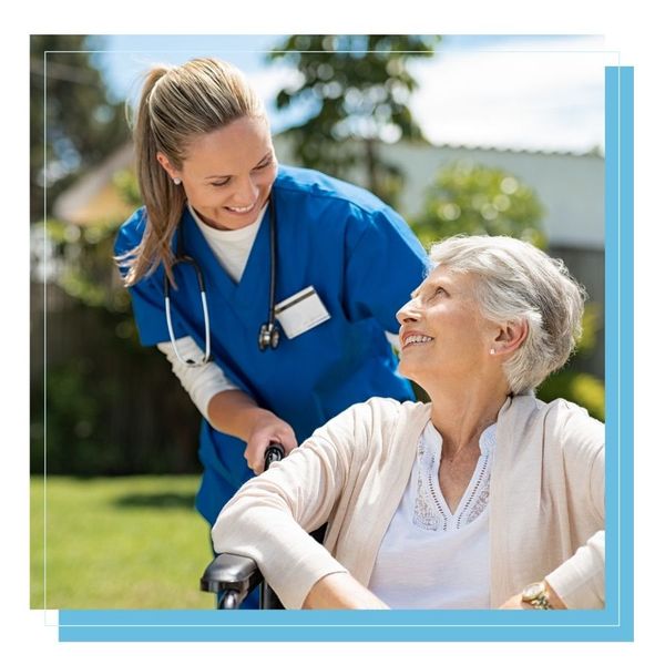 smiling caregiver helping elder lady in wheelchair smiling caregiver helping elder lady in wheelchair