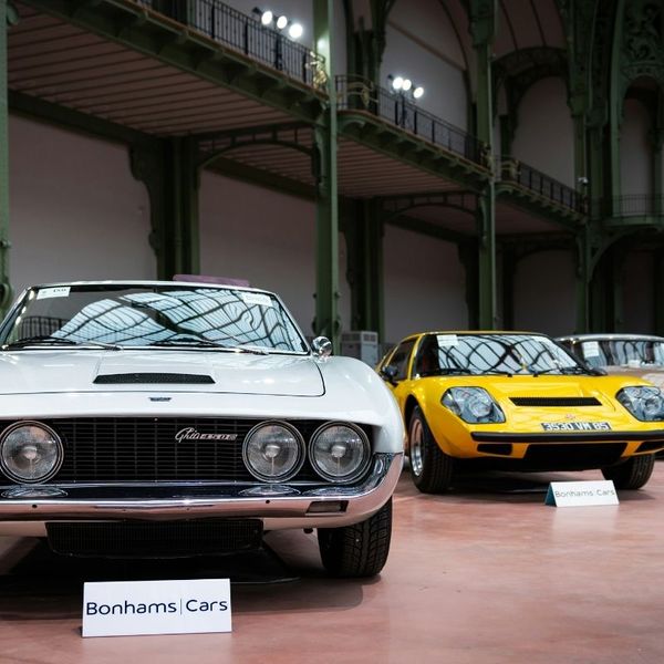 Classic cars parked at an indoor auction