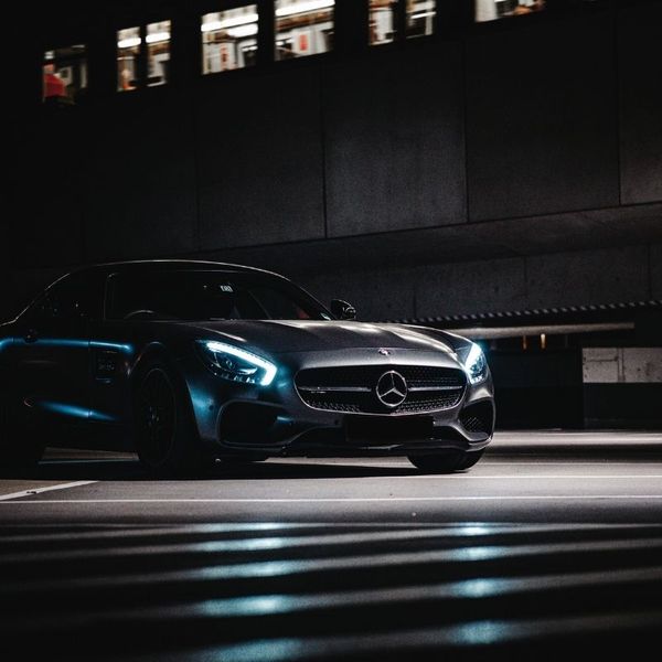 A luxury car driving down the street