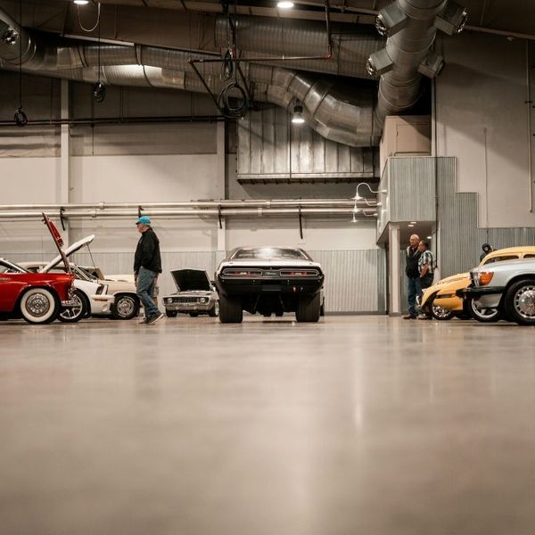 A man observing cars at an auction
