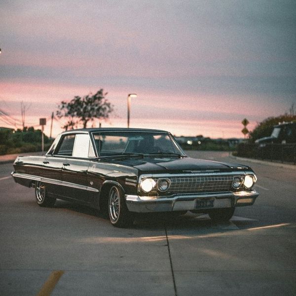 A vintage car parked in a lot