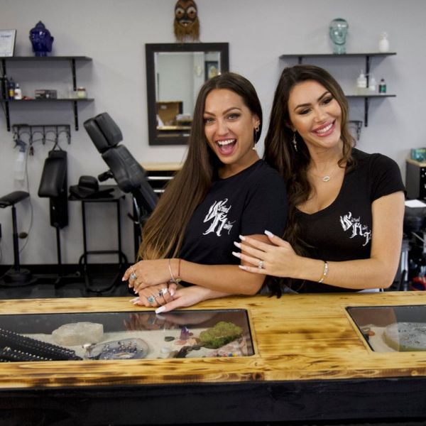 Two beautiful women employees of Sacred Raven Tattoo