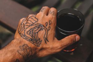 Tattooed Hand Reaching For Beer.jpg