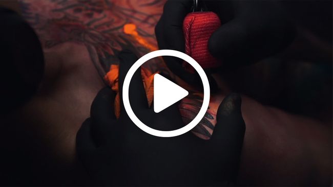 Video Poster - Close up of tattoo artist working