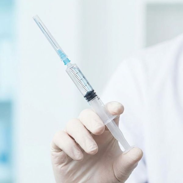 Medical professional holding a syringe for Sculptra injection