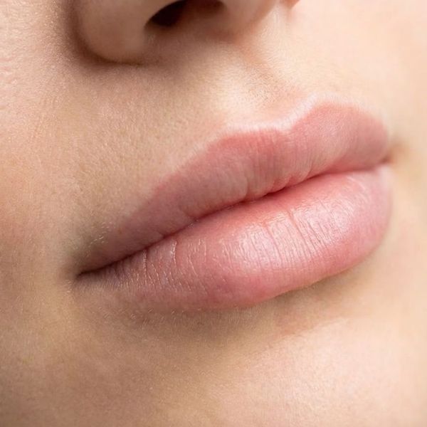  Close-up of natural-looking lips with a subtle, relaxed pout.